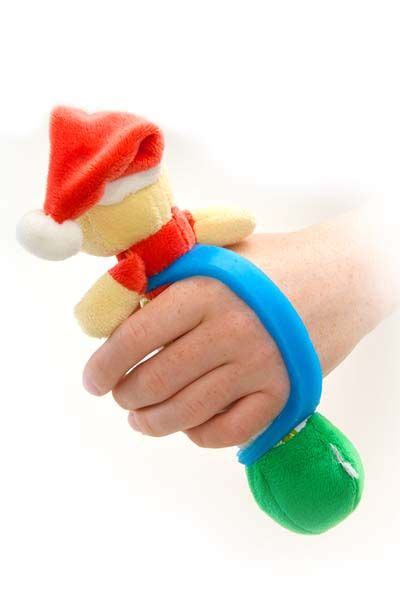 hand holding  stuffed animal wearing  santa hat  blue band