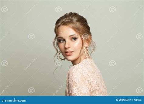 Beautiful Young Woman In Pearls Earring Posing On White Background