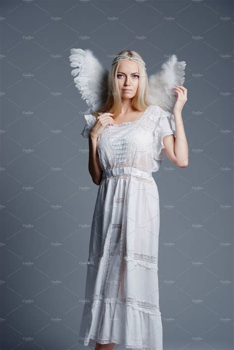 beautiful blonde girl portrait containing angel wings and adult