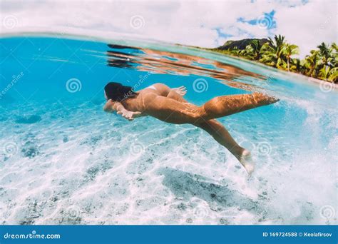 woman swimming underwater  transparent blue ocean  mauritius le morne stock photo image
