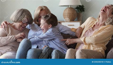 Cute Happy Females Relatives Of Diverse Age Tickling On Sofa Stock