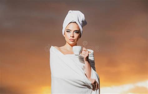 Relaxed Woman In Bathrobe Smelling Coffee In The Night At Dramatic Sky