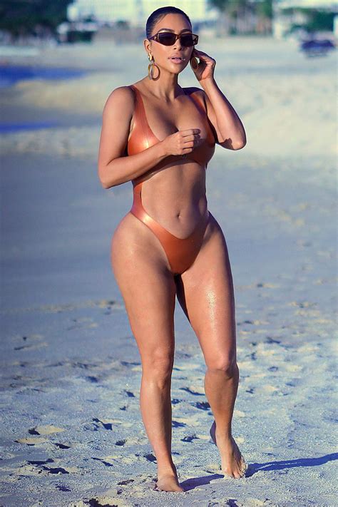 kim kardashian stuns in an orange bikini as she hits the beach in