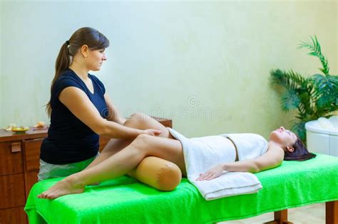 Front View Of Professional Massage Therapist Giving Massage On Woman