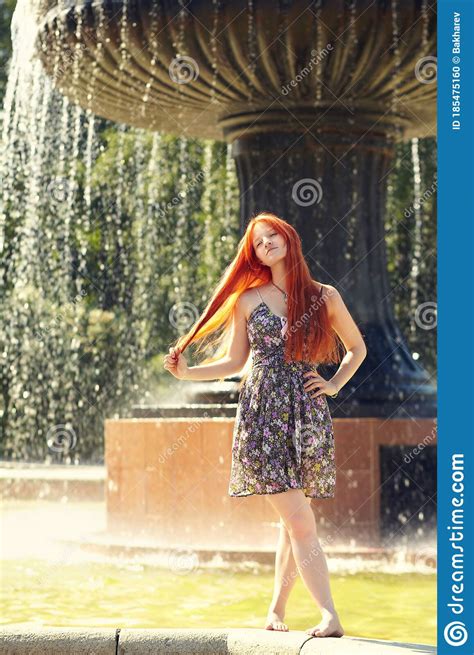 portrait af a beautiful redhead woman outdoors stylish