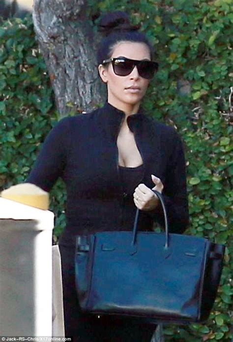 Kim Kardashian Wears Tight Fitting Workout Gear As She Carries Ts