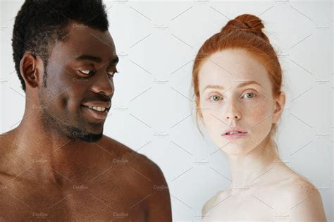 portrait of happy loving interracial couple shirtless african man