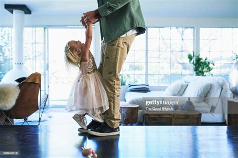 Daughter Standing On Feet Of Father Dancing Photo Getty Images