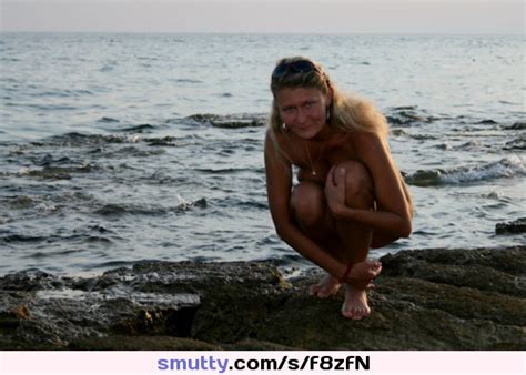 outdoor nude beach ocean tanlines smiling