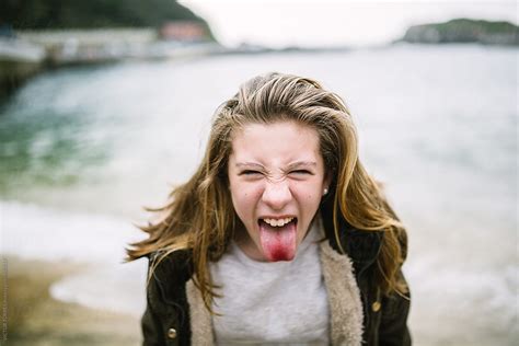 teenager sticking  tongue  stocksy contributor victor torres