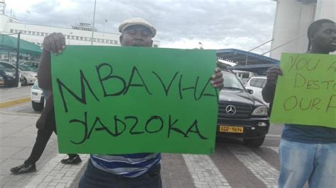pictures kasukuwere returns to zim…confronted at airport by angry zanu
