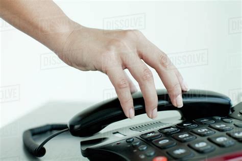 hand picking  telephone receiver cropped stock photo dissolve