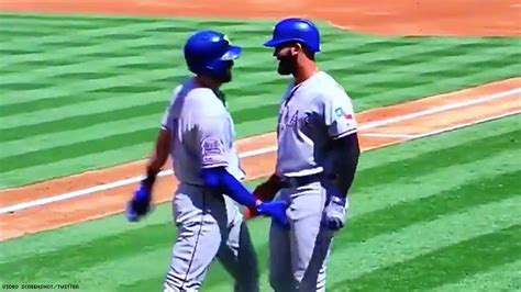 baseball players celebrate home run by grabbing each other