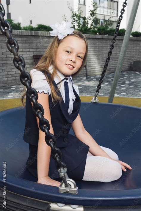 cute elementary schoolgirl in uniform at playground schoolgirl in a
