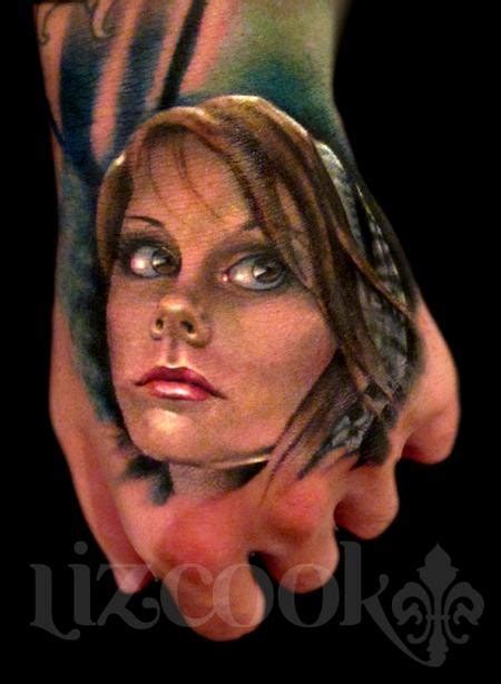 realism style colored hand tattoo of woman face tattooimages