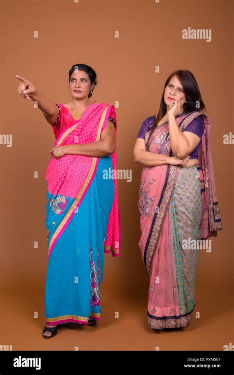 two mature indian women wearing sari indian traditional clothes stock