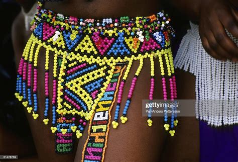 a maiden shows her traditional zulu skirt made of beads as she s