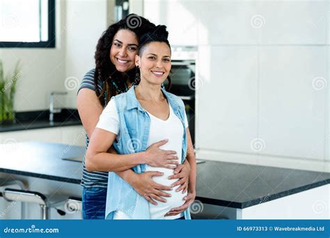 Pregnant Lesbian Couple Standing Back To Back Royalty Free Stock
