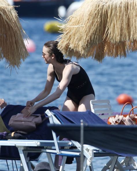 lily collins candids in black swimsuit at the beach in