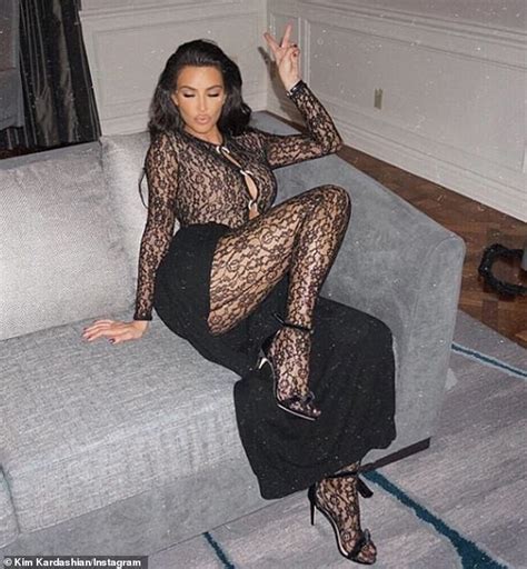 kim kardashian stuns in sheer bodysuit as she pouts her lips and poses on a couch daily mail