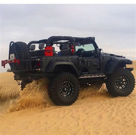 black  door jeep jk wth lift  matching wheels riding  sand lifted jeep jeep sport