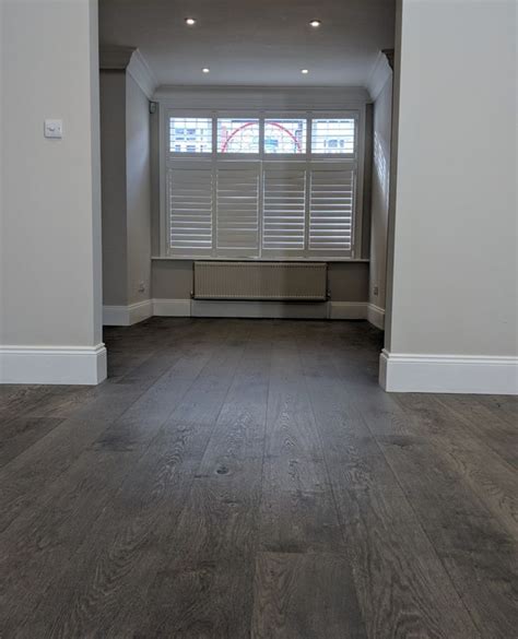 dark wooden boards complement  light grey walls light grey walls grey wood floors