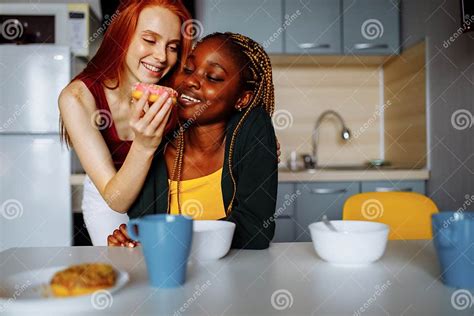 Happy Lesbian Couple Preparing Breakfast In The Kitchen Stock Image