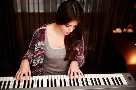 Young Pretty Woman Sensually Playing On Electric Piano And Singing A