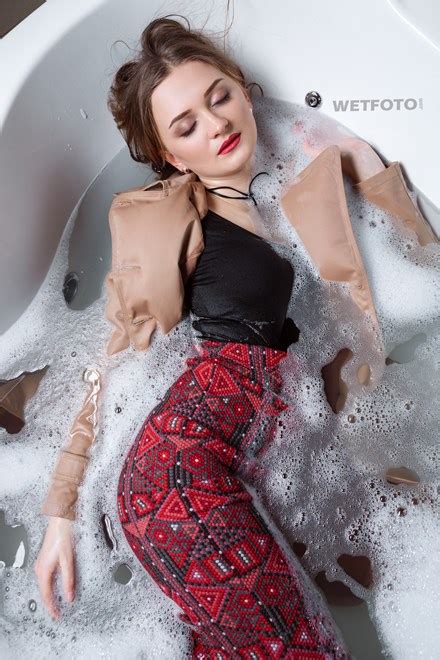 fully clothed girl in coat and hat get soaking wet in bubble bath wetlook one