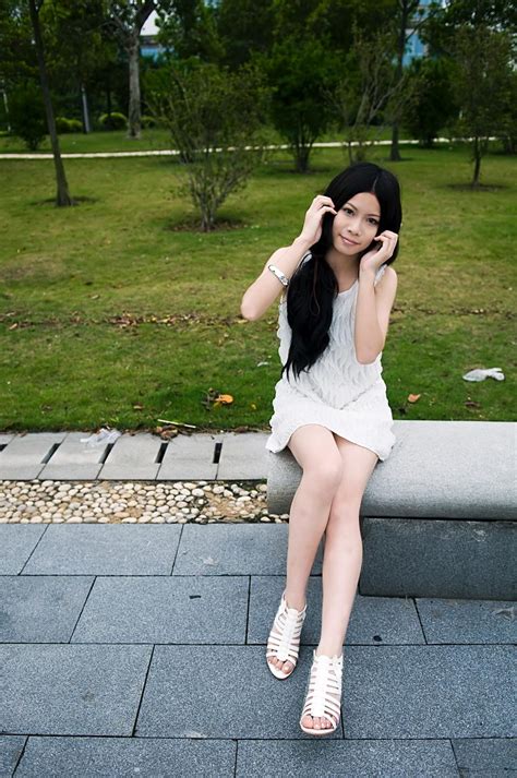 free photos a beautiful chinese girl posing on a bench outdoors peopleshot
