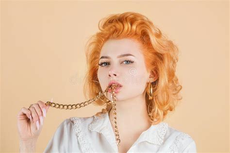 Redhead Woman Close Up Portrait With Golden Chain In Mouth Stock Image