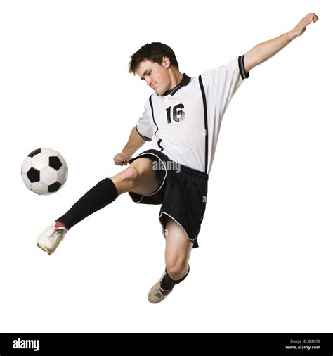 young man kicking  soccer ball stock photo alamy