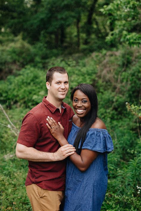 Posed Portrait Of Smiling Attractive Interracial Couple By Stocksy
