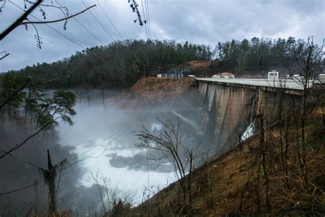 lake lure dam withstands floods faces delays  urgent repairs