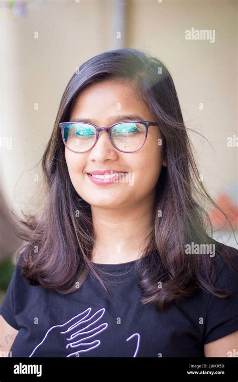 A Vertical Shot Of A Beautiful Indian Woman Wearing Glasses While