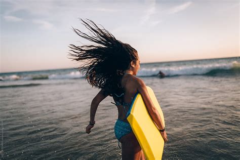 cute teen girl with a bodyboard at the beach by victor torres surfer
