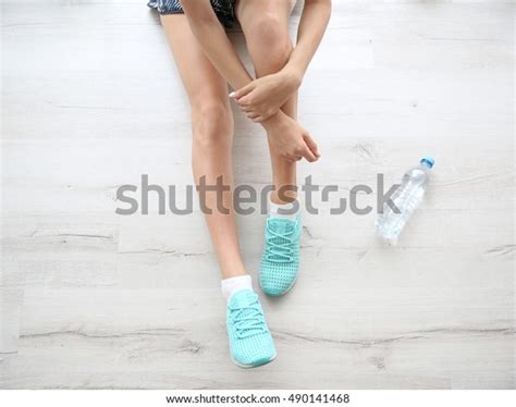 woman wearing mint sneakers  wooden stock photo  shutterstock