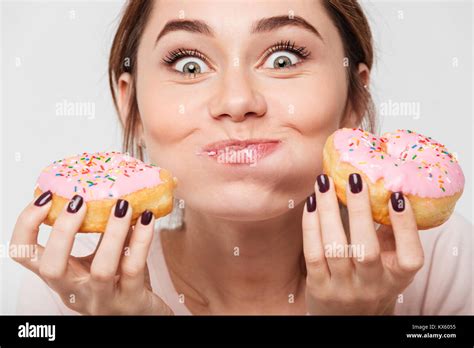 close  portrait   satisfied pretty girl eating donuts isolated