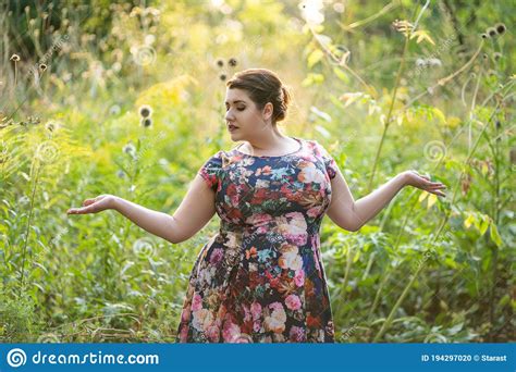 plus size fashion model in floral dress outdoors beautiful fat woman