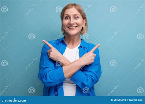 Mature Woman Shows Her Hands In Different Directions On A Blue