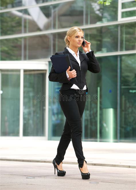 business woman walking and talking on cellphone in the city royalty free stock image image