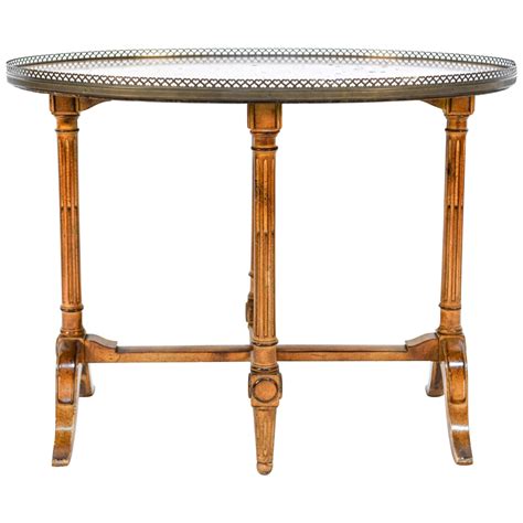 oval shaped sienna marble top french side table with brass gallery and