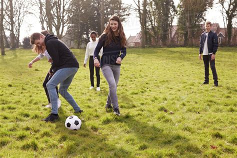 group  teenagers playing soccer  park  stock photo dissolve
