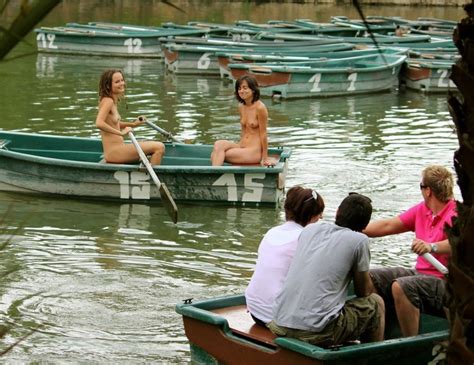 Happy Embarrassed Naked Girls Enjoying A Leisurely Ride In A Rowboat