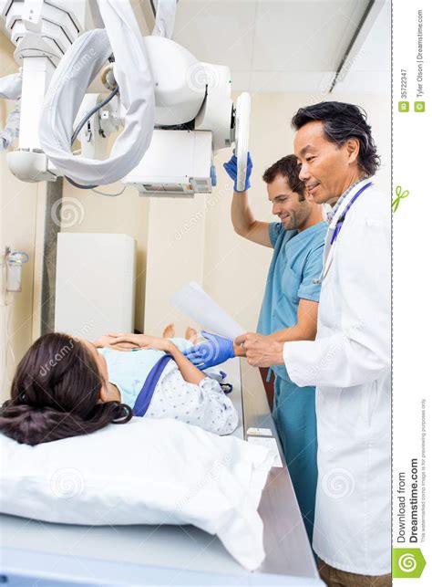 medical team preparing patient for xray royalty free stock
