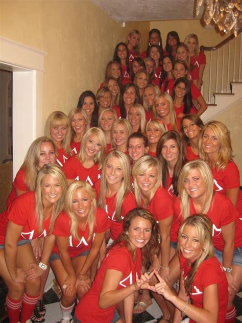 A Group Of Women In Red Shirts Posing For A Photo On The Stairs With
