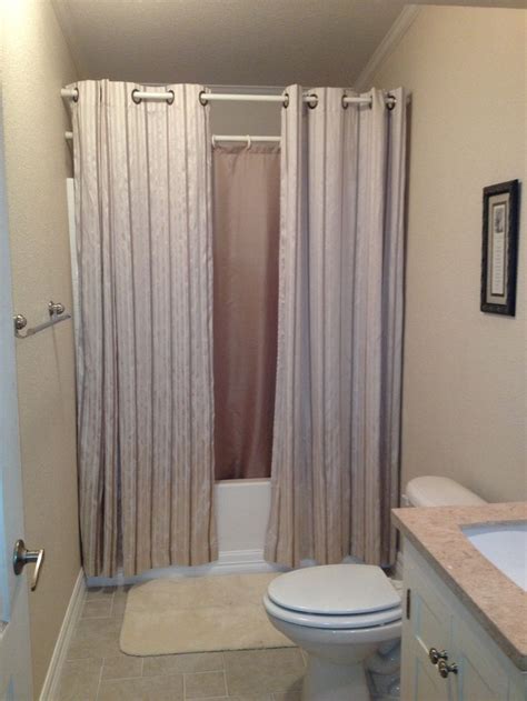hanging shower curtains   small bathroom  bigger