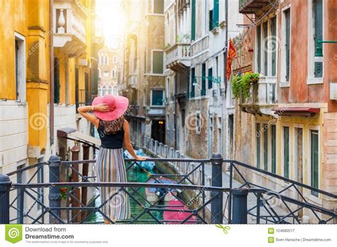 traveller woman enjoys the view to a canal with passing by