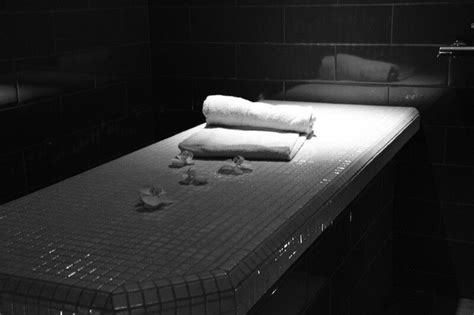 folded towels sit  top   mattress   black  white room