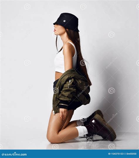 Young Beautiful Hipster Girl Sitting On Her Knees Full Body In Shorts